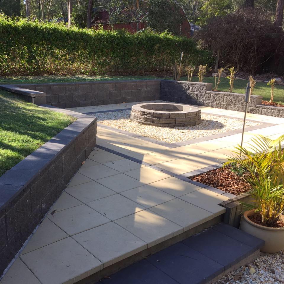 Paved fire-pit area with charcoal block walls.