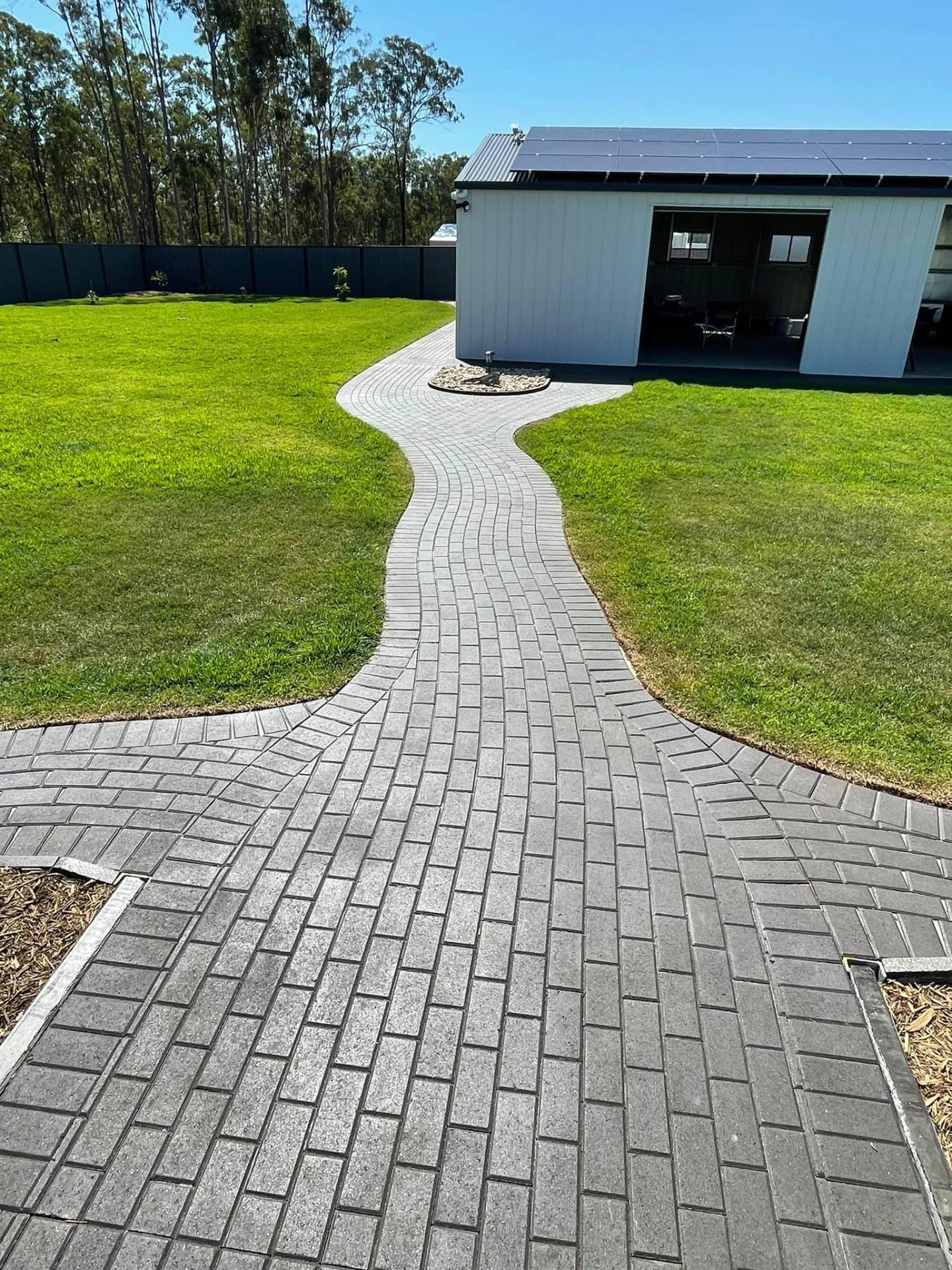 Sweeping paver path through fresh-laid lawn.